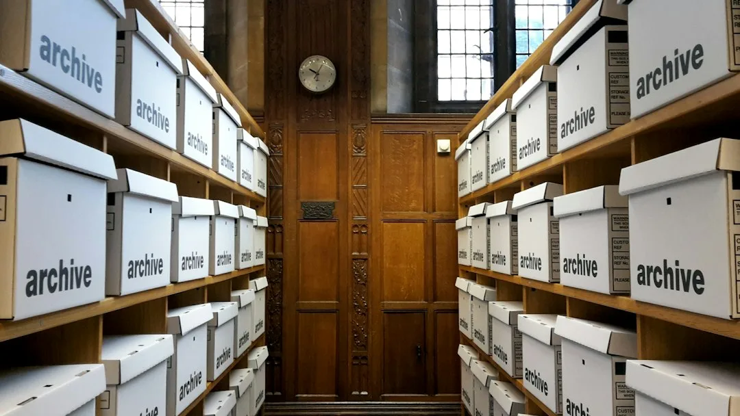 Rows of archive boxes on wooden shelves