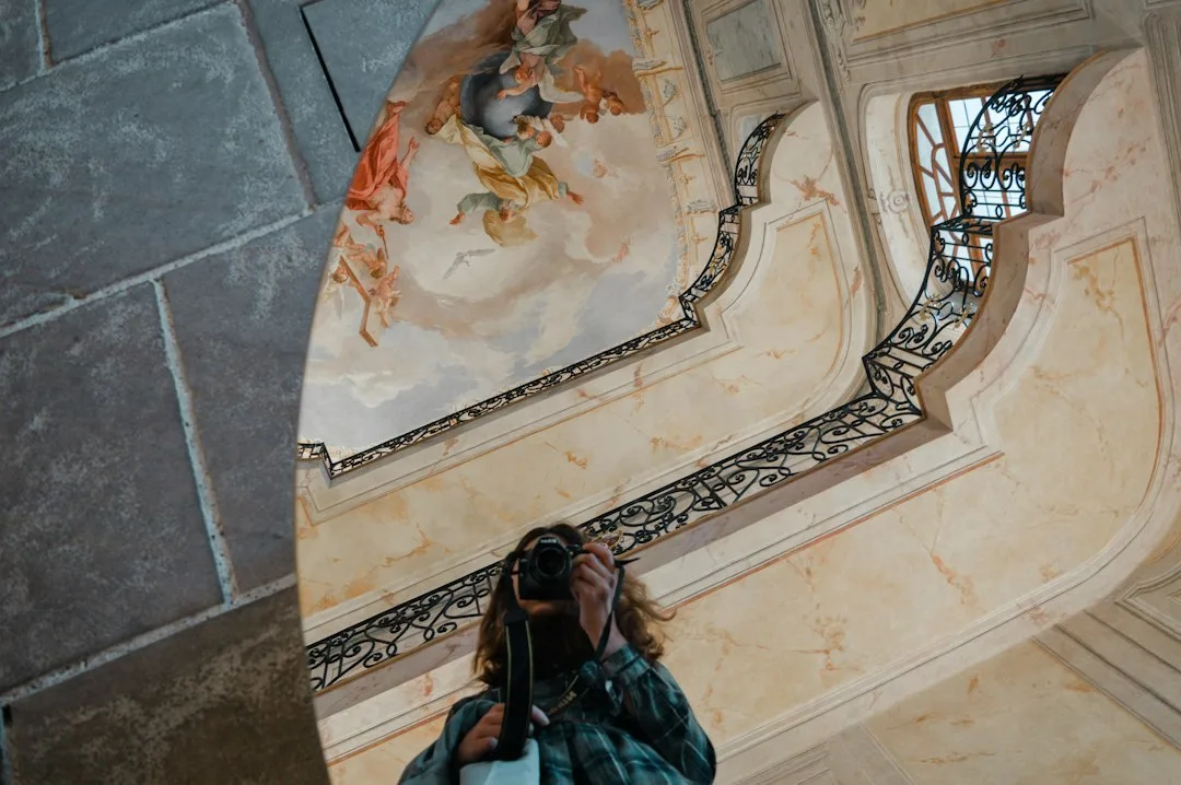 Person taking a photo in a grand staircase